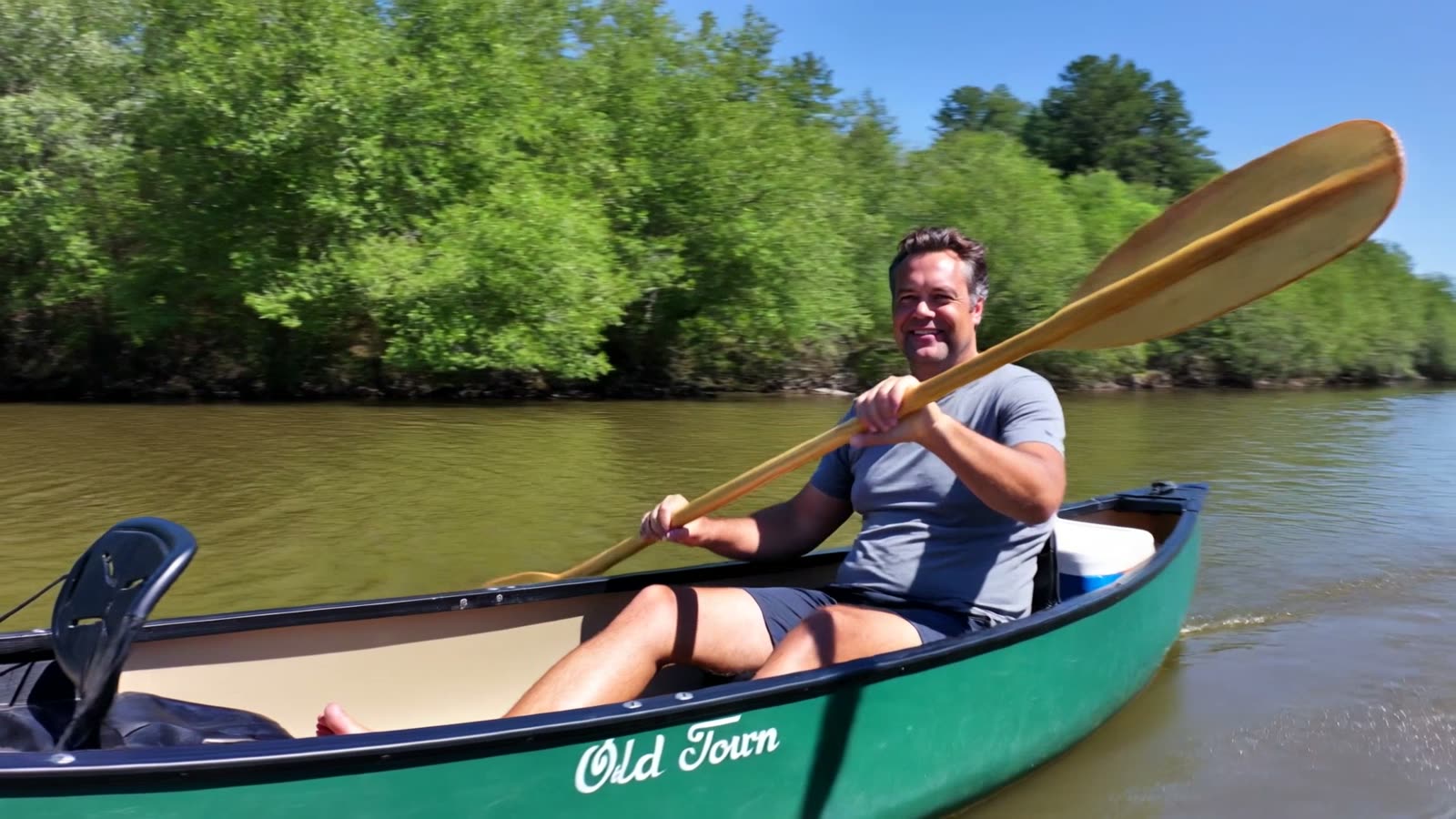 Justin Hamilton paddling a canoe on a Kentucky river