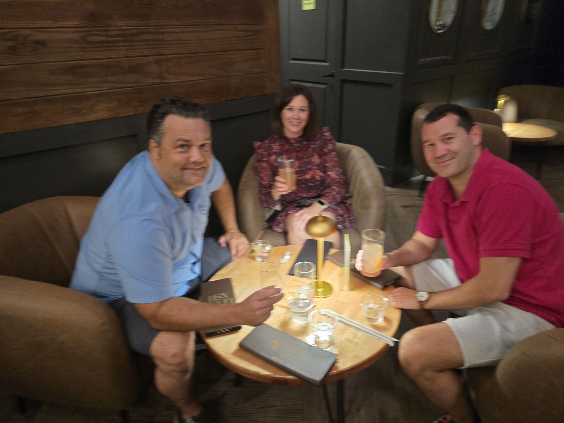 Friends talking around a table at a bar