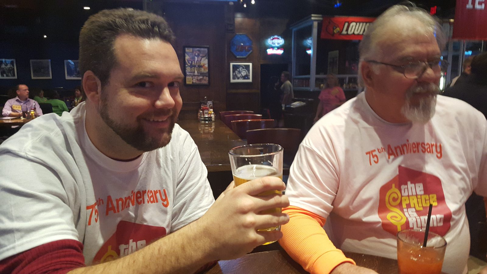 Justin and a friend talking over a beer