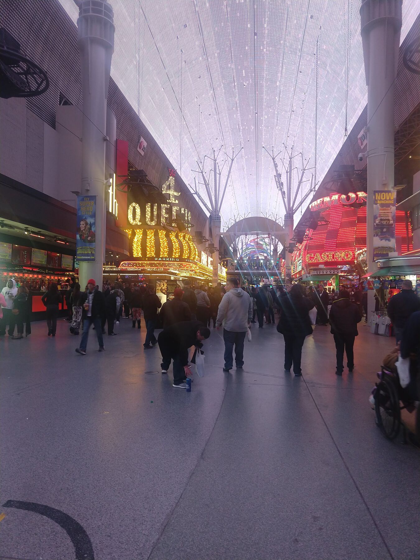 A crowded street under a lit canopy