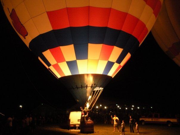 A hot air balloon glowing at night