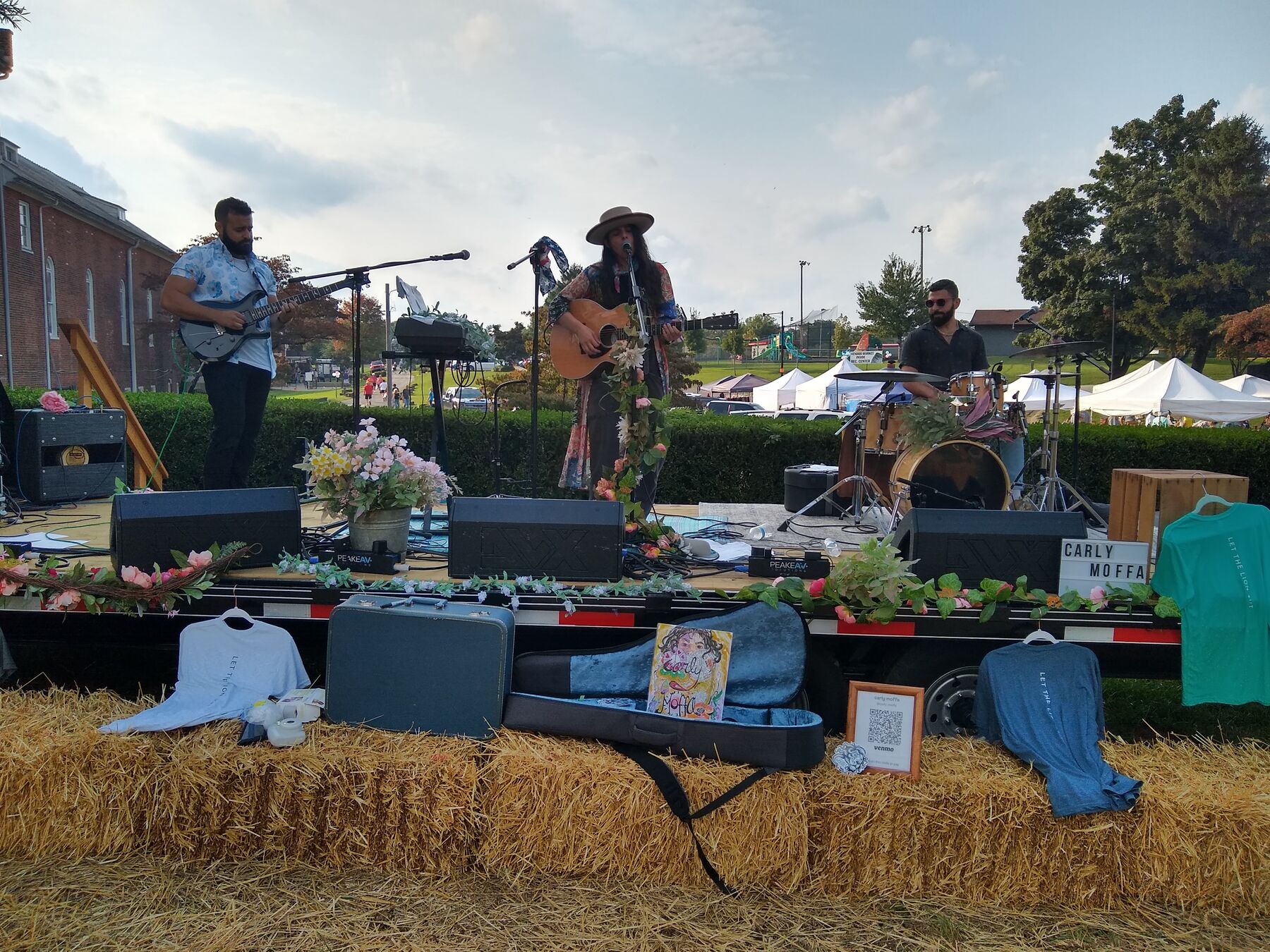 A band on a stage of hay bales