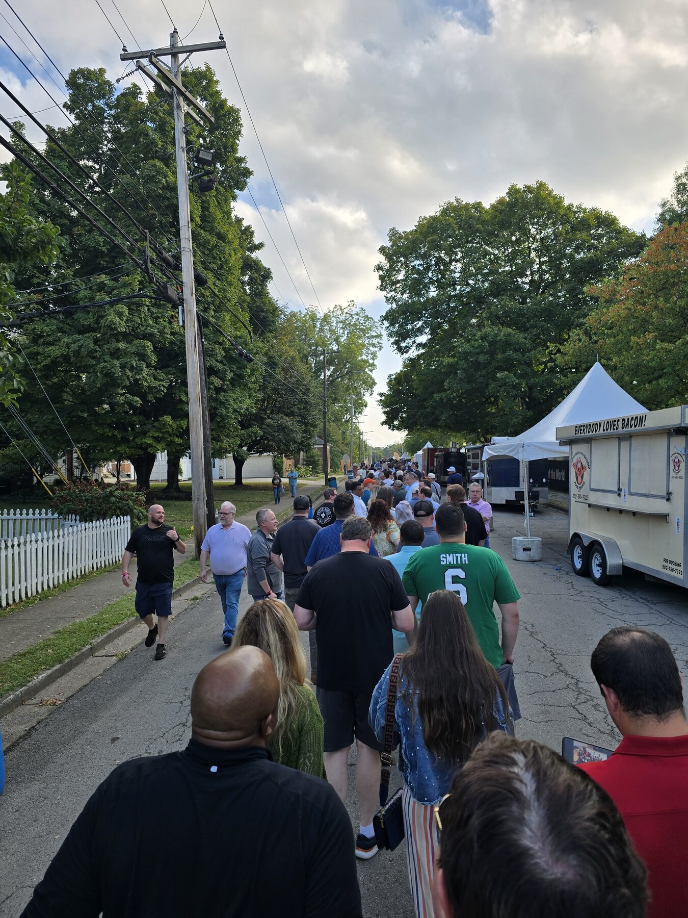 A crowd walking to a festival