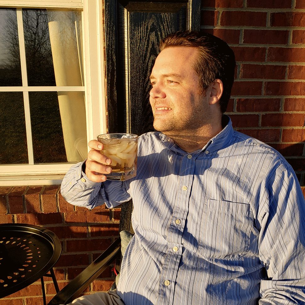 Justin with a pour on a brick patio at sunset