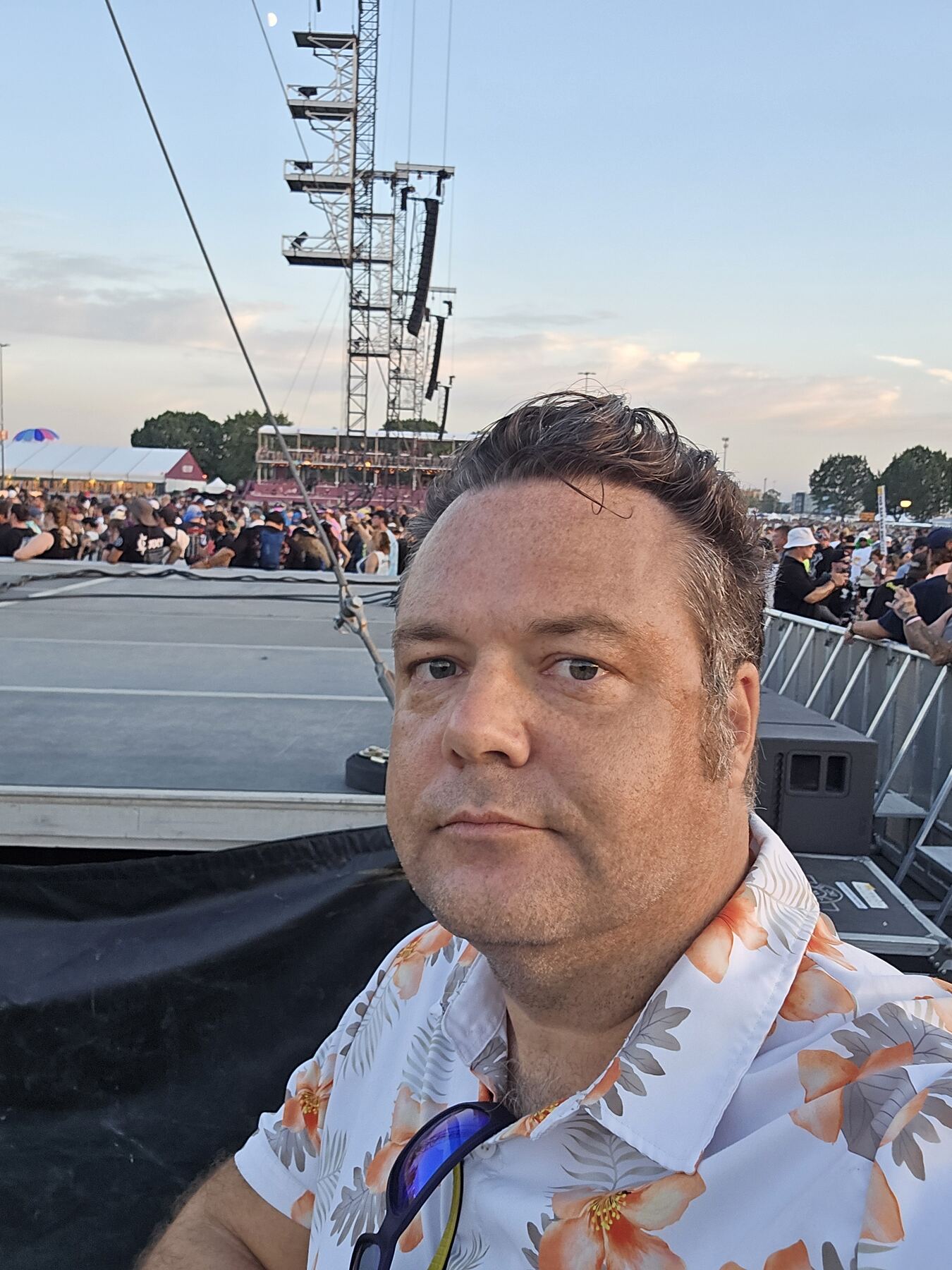 Justin at a festival, stage behind him