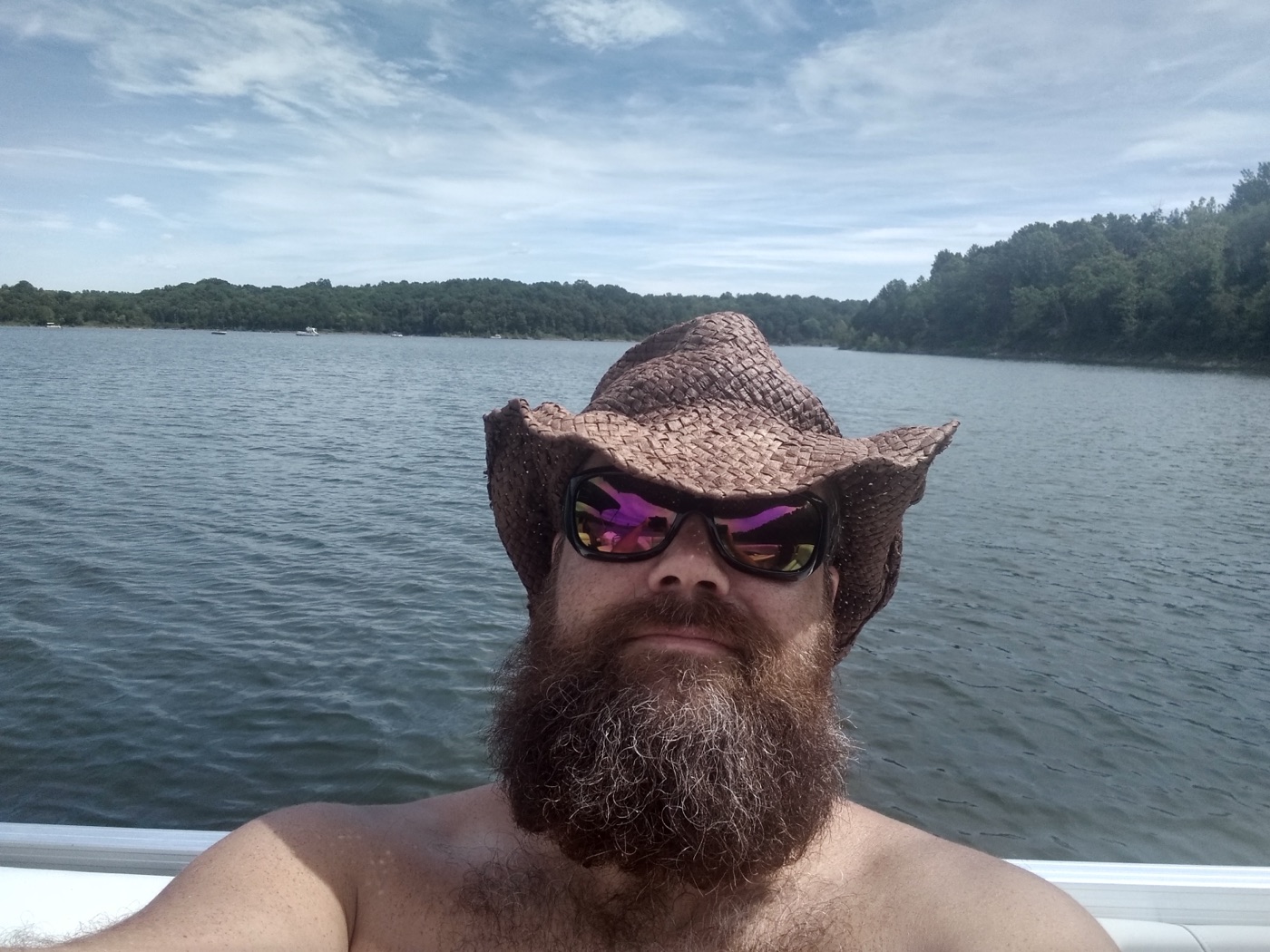 Justin in a straw hat on the lake
