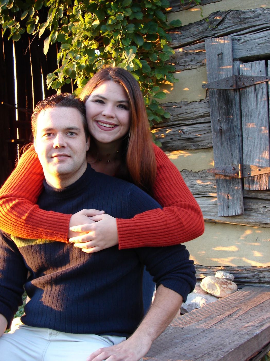 Justin and a friend by an old log cabin