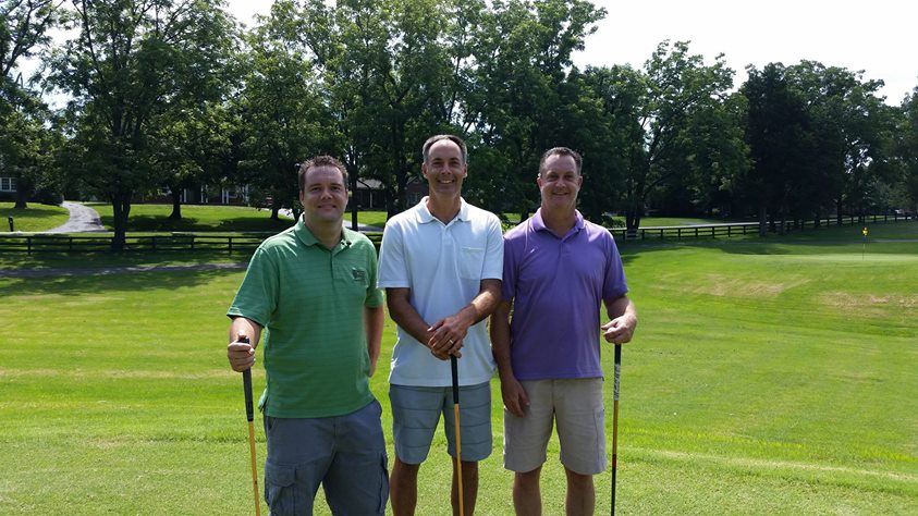 Three friends on a golf course