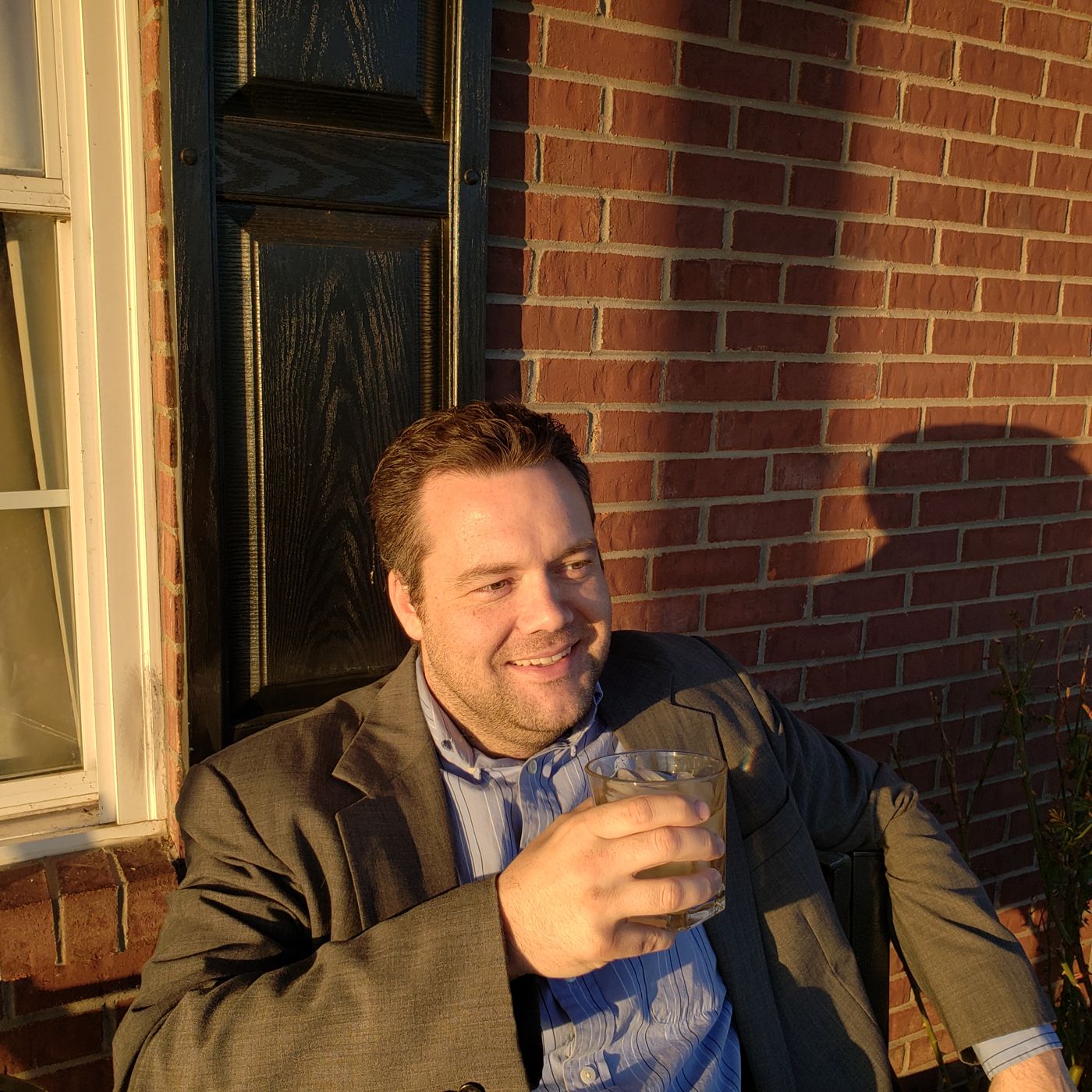 Justin with a pour on a brick porch