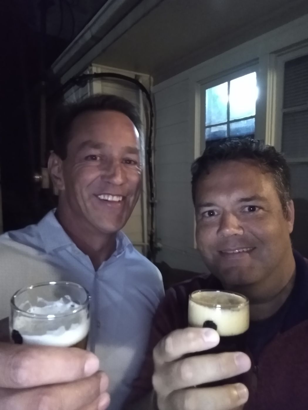 Justin and a friend raising a glass