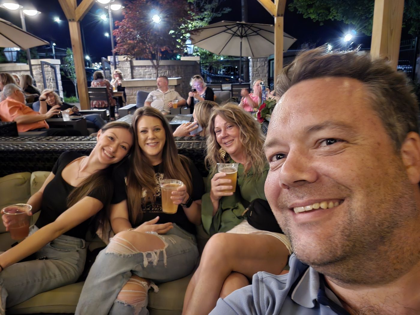 Justin and friends on a patio at night