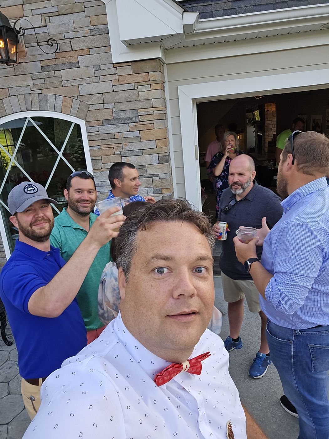 Justin and friends with drinks outside