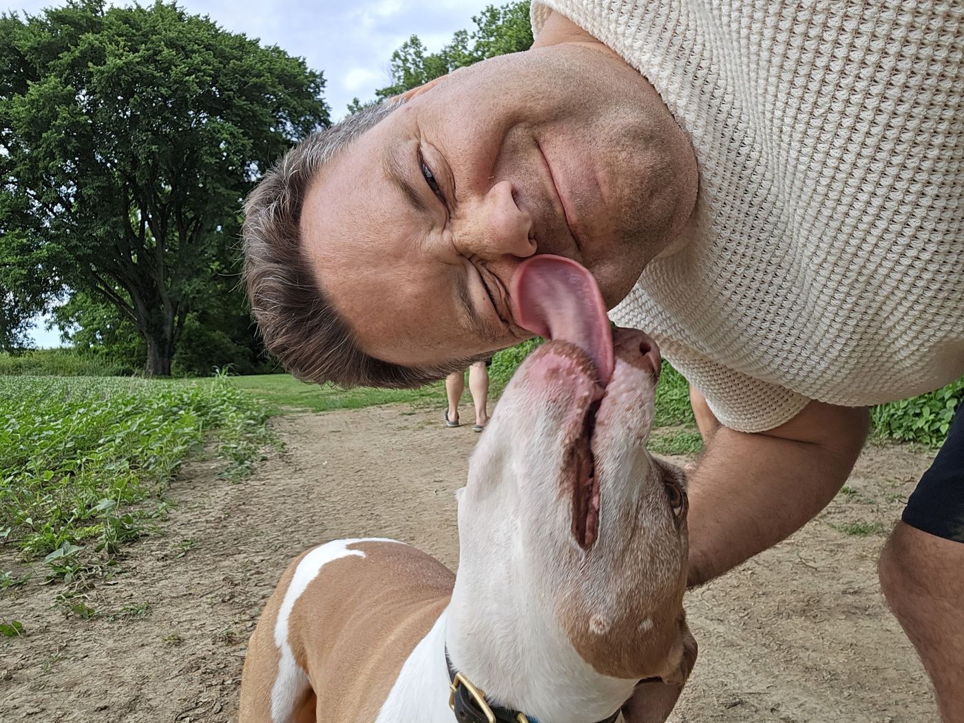 Justin getting kissed by a dog