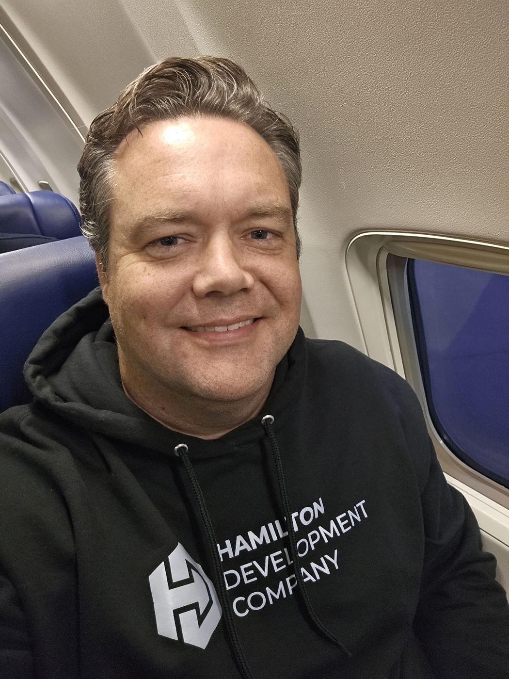 Justin in a Hamilton Development Company hoodie