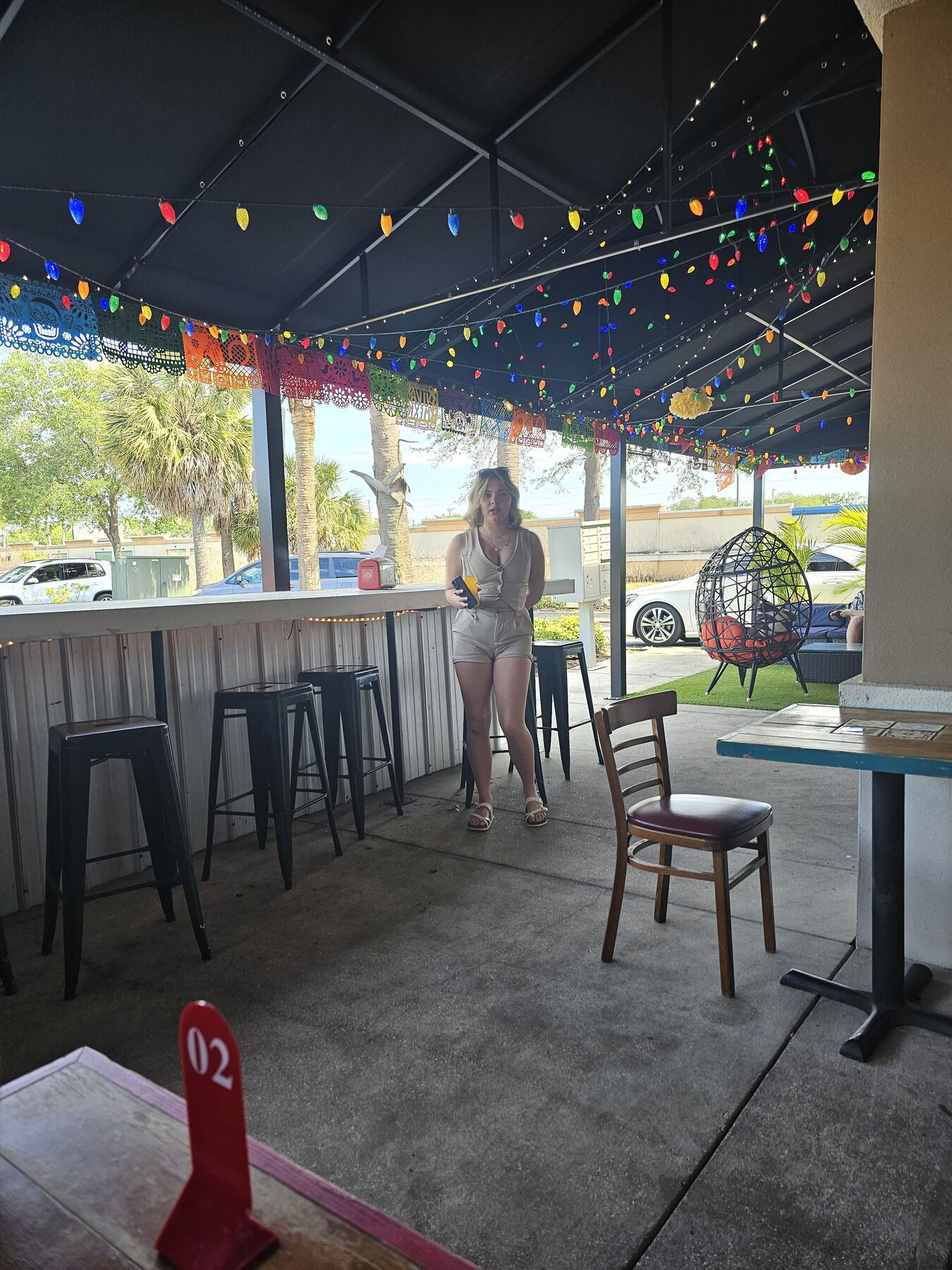 A patio bar under string lights